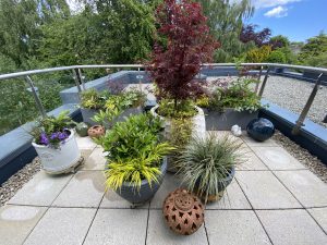 Stylish tall planters with lush greenery and floral accents.