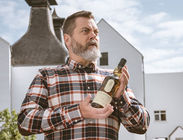 Nick Offerman holding a bottle of Lagavulin whisky, styled by Angela Moffat, a stylist based in Edinburgh, Scotland, for a Lagavulin campaign.